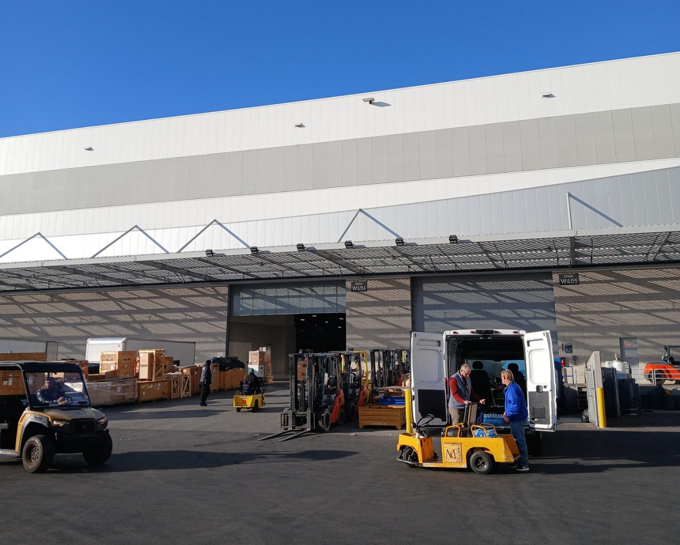 491638782_1207752748019958_7338311901812675546_n Shipping dock at a facility, showing loading and unloading operations.